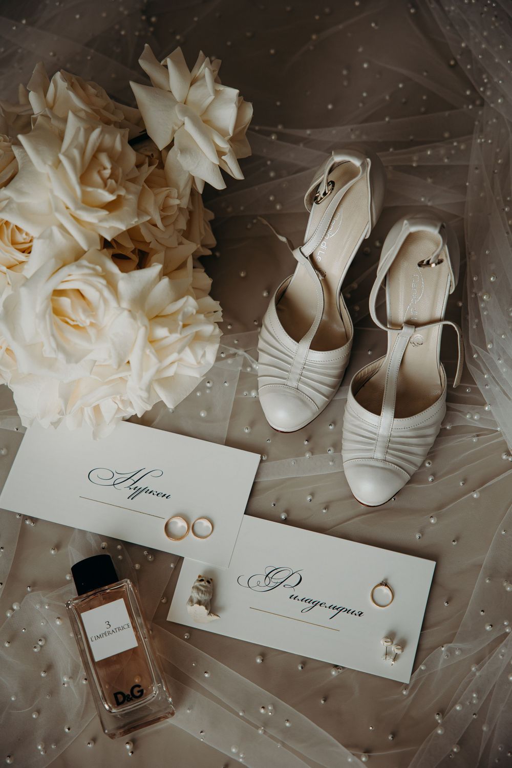Wedding shoes, rings, and flowers arranged in a wedding flat lay