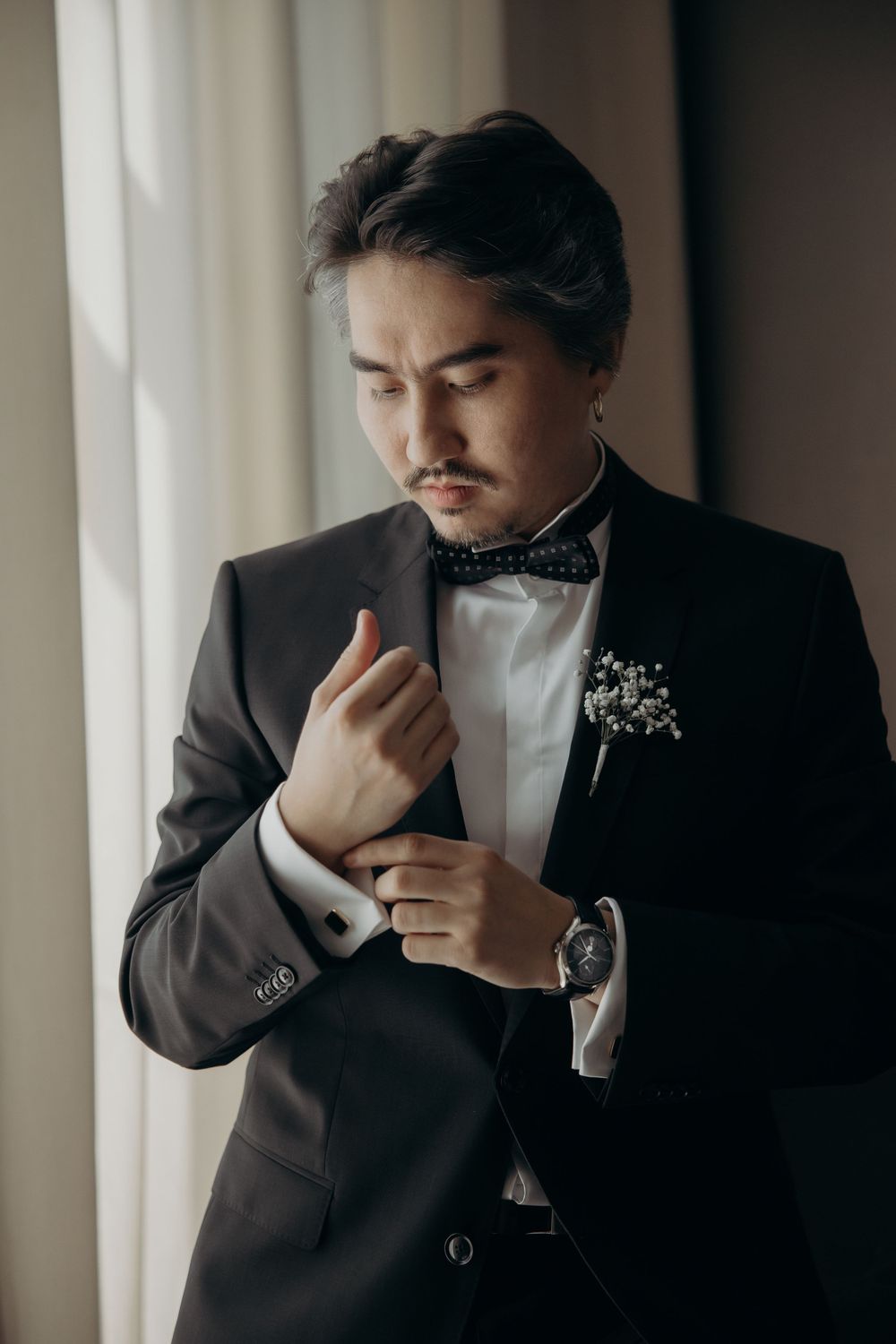 Man in a black tuxedo getting ready on his wedding day
