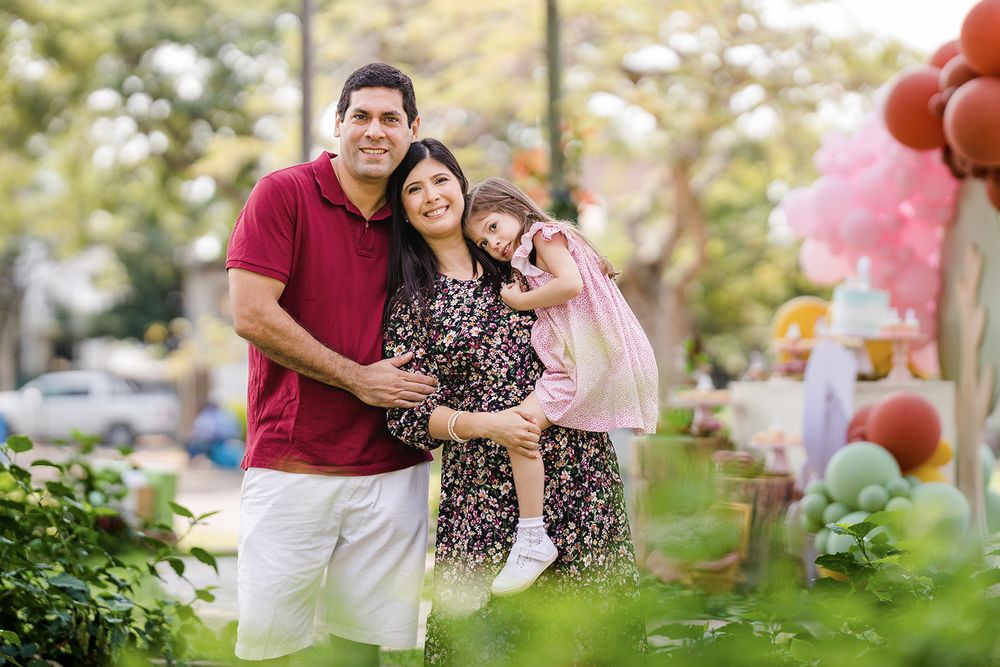 Black family portrait of father, mother and daughter in a garden in Maputo Mozambique