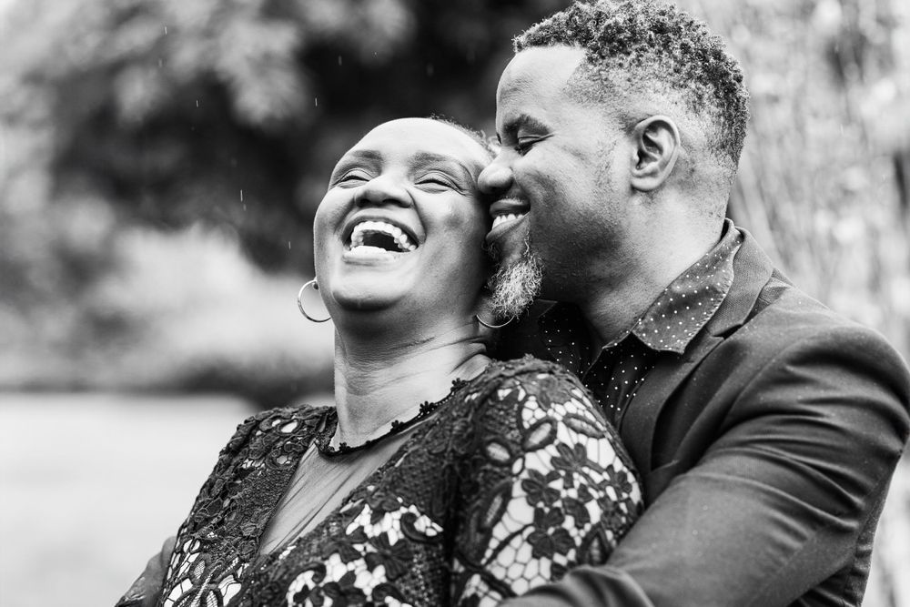 A Black couple hugging and laughing in an embrace in Nairobi, kenya.