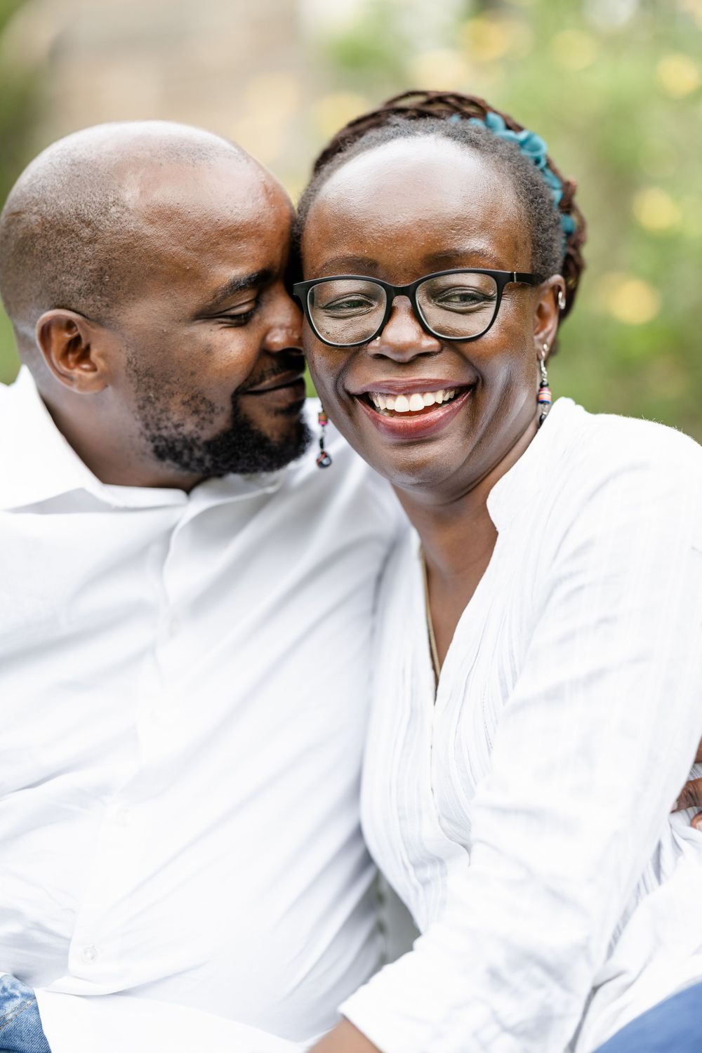 A Black couple portrait sitted in a field of yellow flowers in Nairobi, kenya.