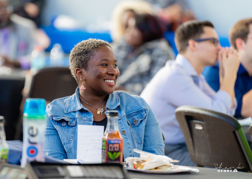 Attendee enjoying refreshments and conversation at casual business gathering.