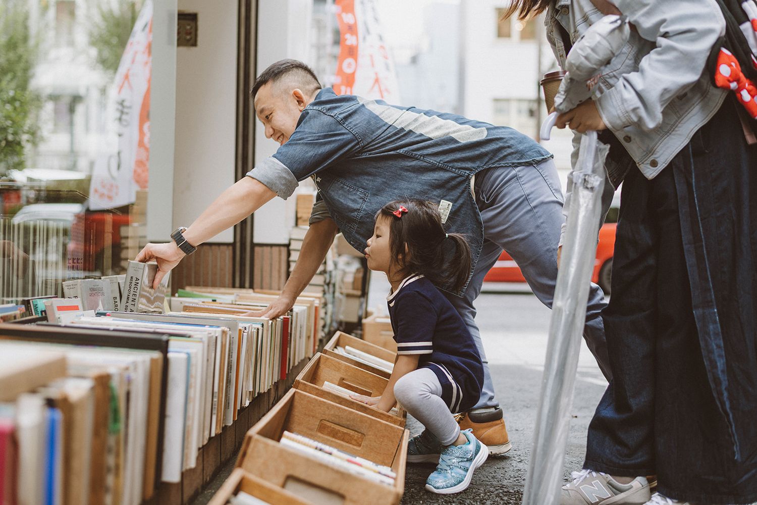 Family exploring Tokyo during a vacation in Jimbocho book district