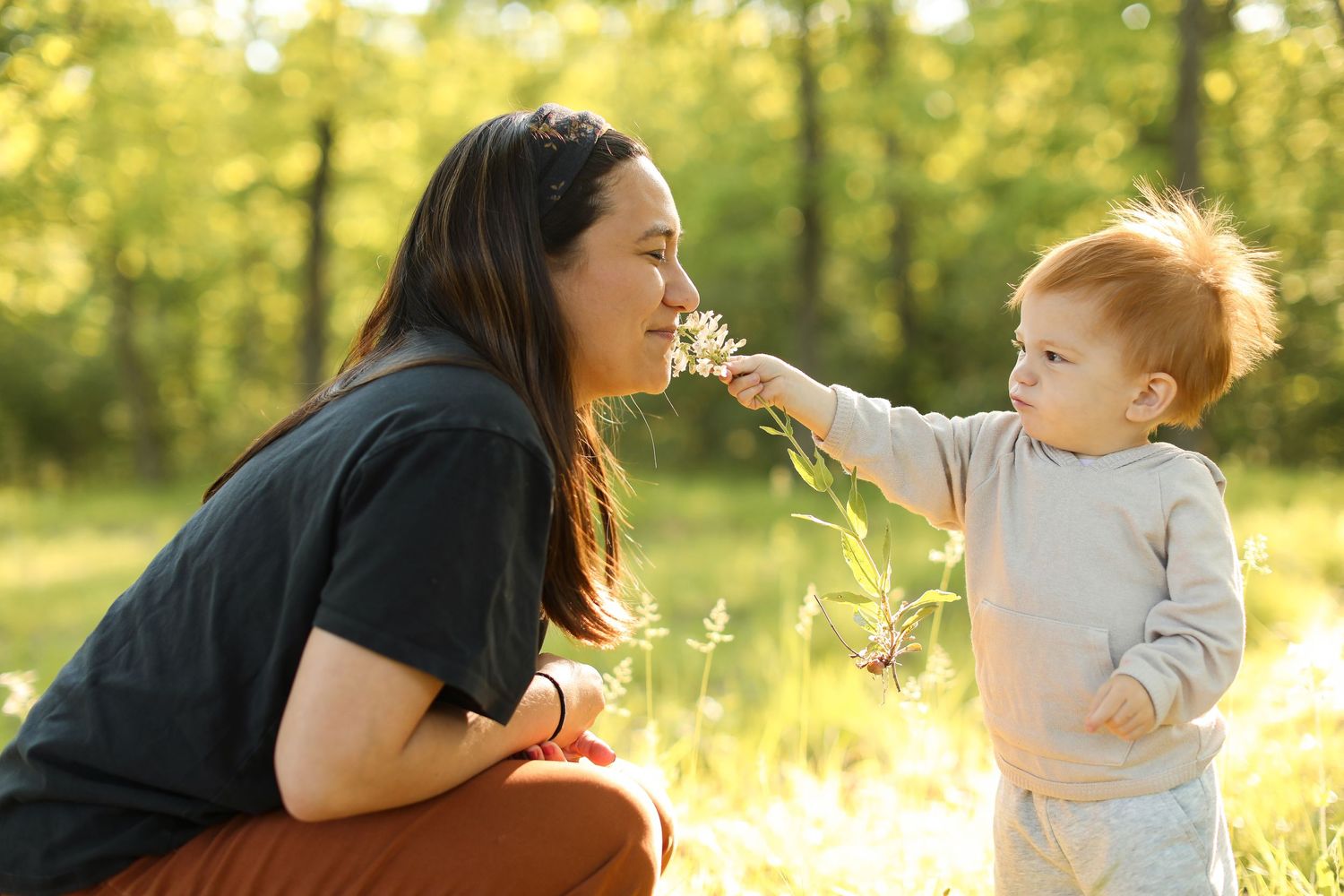 Candid moments captured in a sunlit field with tall grasses.