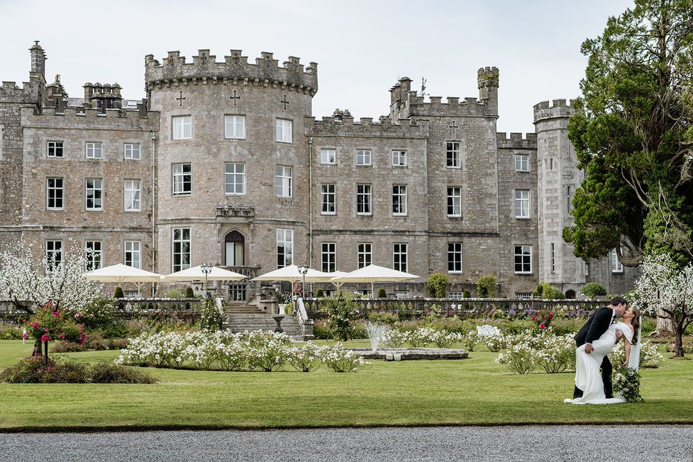 Majestic castle wedding venue with beautiful landscaped gardens in foregroun, Historic Irish castle wedding venue at sunset.