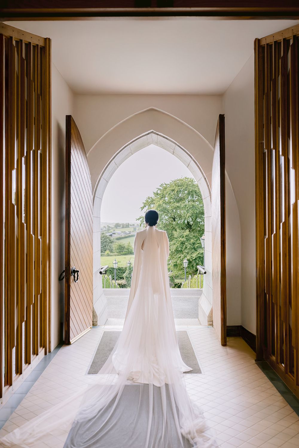 Bride walking out the church at a Galway church wedding, elegant and timeless photograph by Dina Ozola.