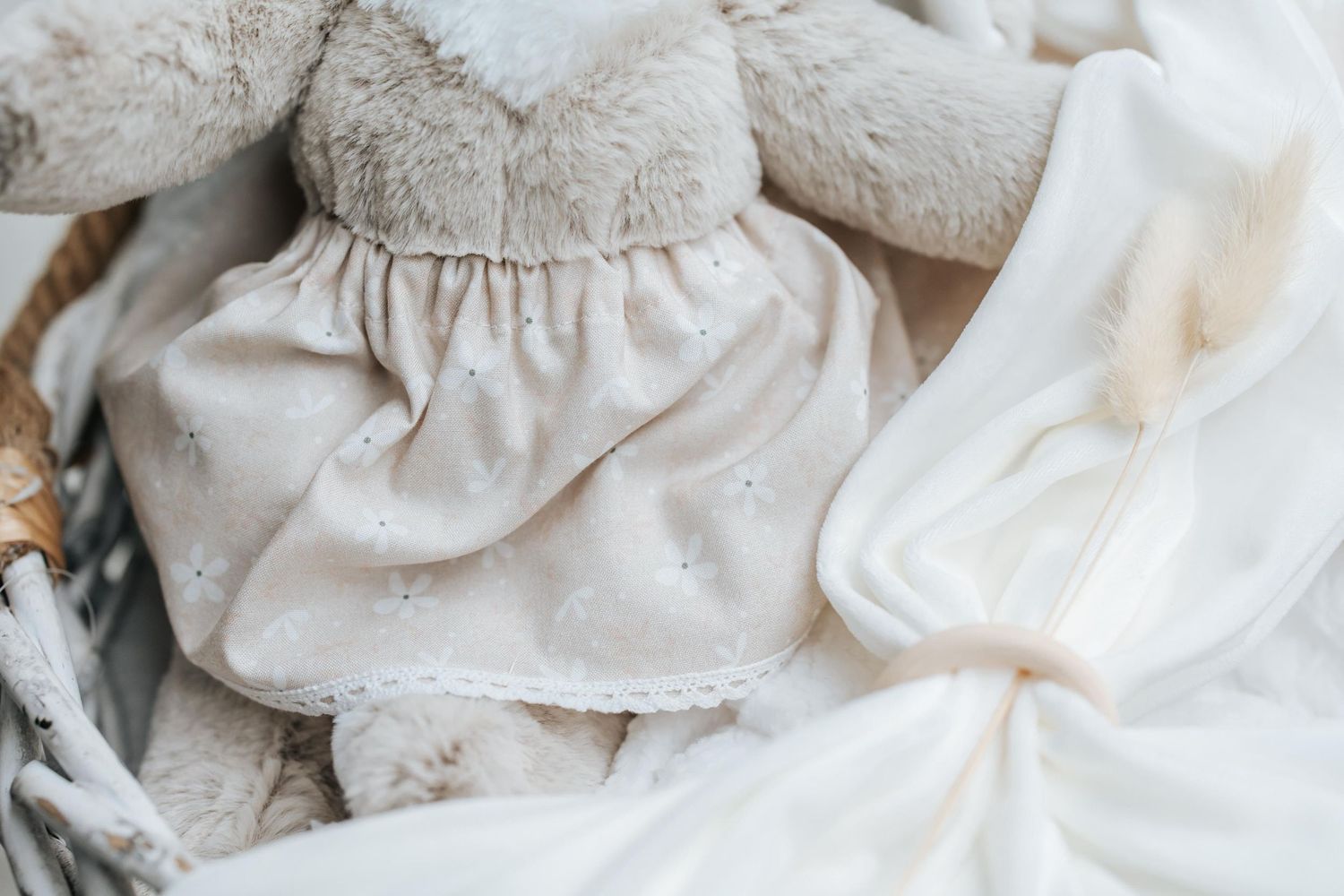 Soft white textured fabric with delicate polka dot pattern in natural light.
