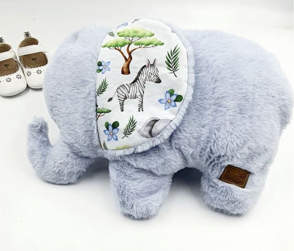Soft gray plush elephant with safari animal print fabric on ear.