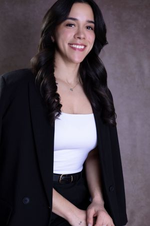 Contemporary fashion portrait showcasing a black blazer and white top ensemble.