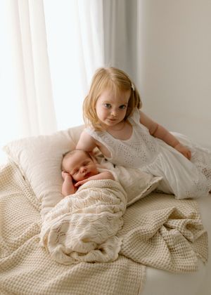 A series of white knit blanket photographs with dreamy natural lighting shows a peaceful and serene composition.