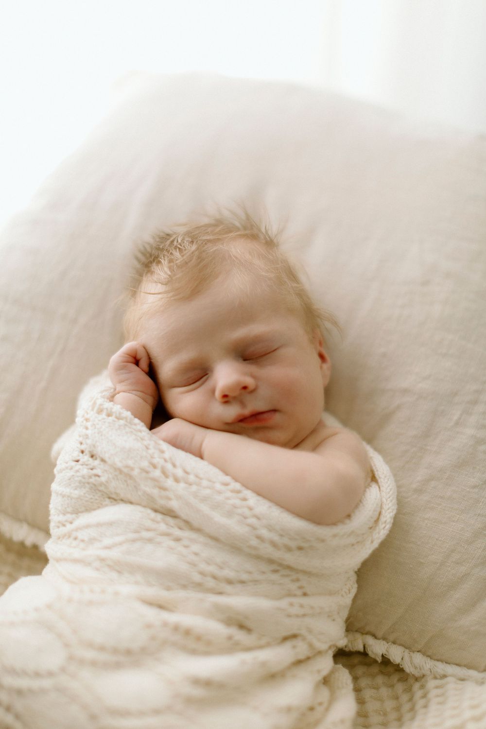 A sleeping newborn baby swaddled in soft white lace fabric photographed in a composite style showing multiple angles.