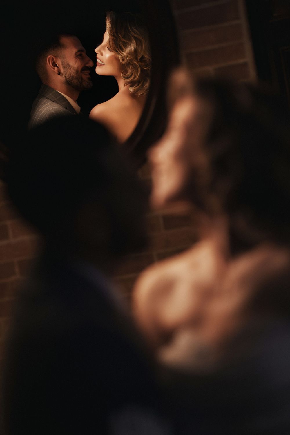 A romantic silhouette series shows a couple in intimate poses against a dark background with warm lighting.