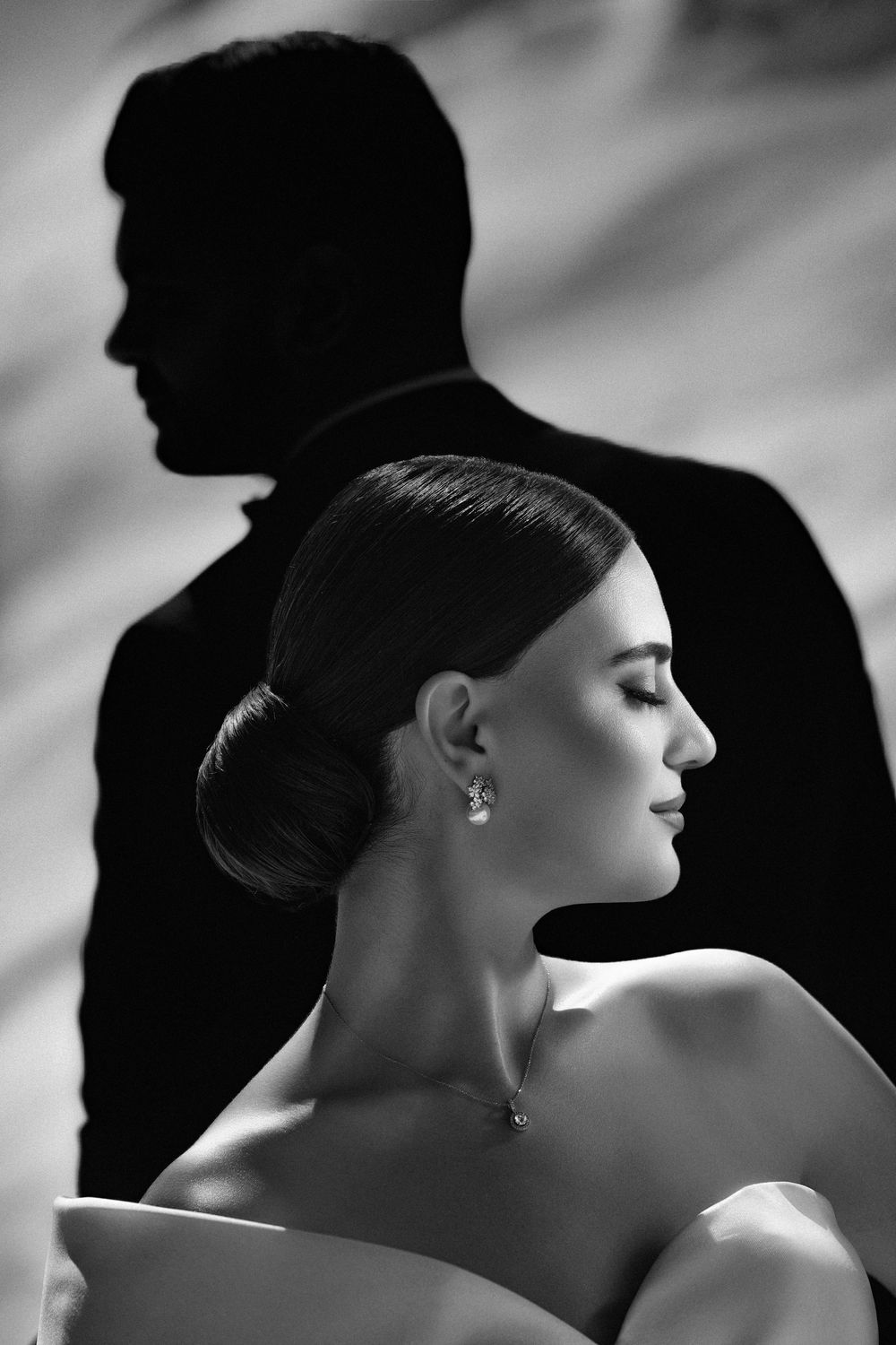 Artistic black and white portrait series showing elegant silhouettes and profiles against dramatic lighting.