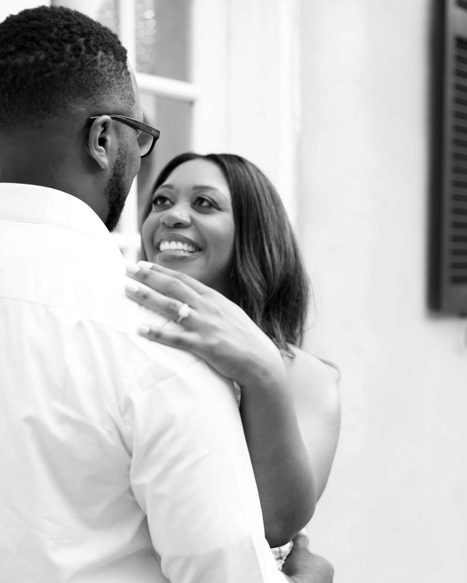 Close up of clasped hands showing wedding rings and a tender moment.