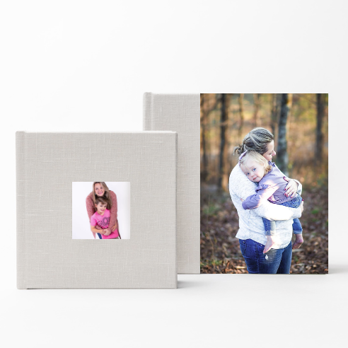 Professional photo albums featuring family portraits with gray linen covers.