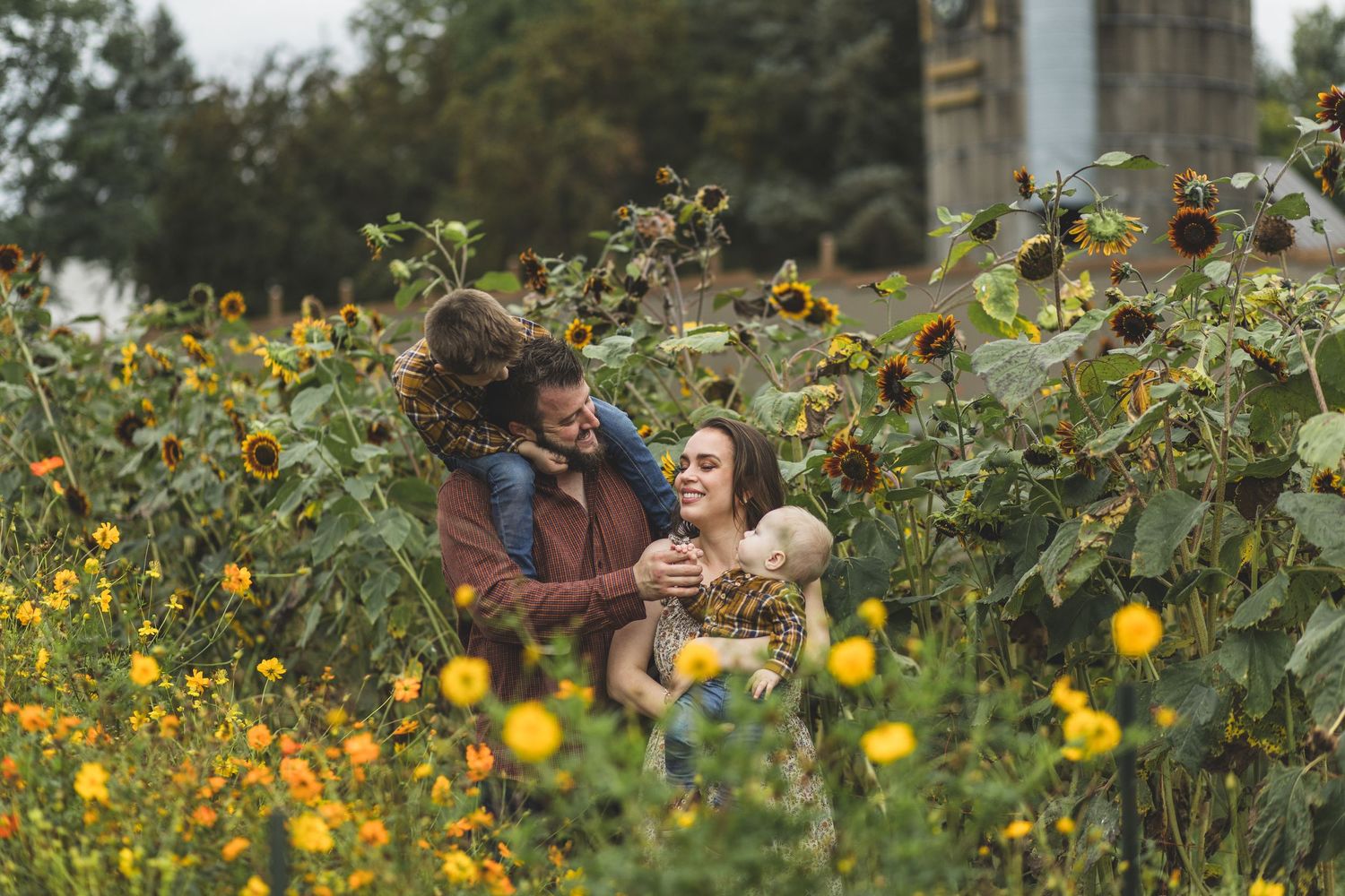 A family takes a casual stroll together on a grassy path during a summer day photo shoot.