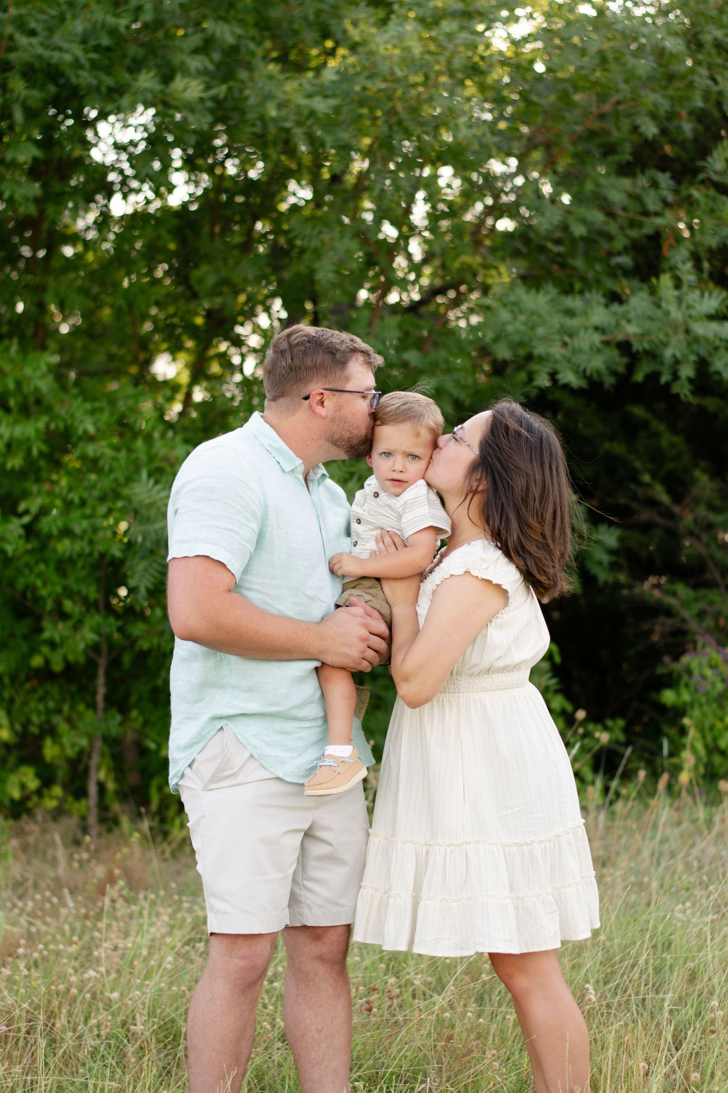 Young family giving kisses to their son in Grapevine, Texas