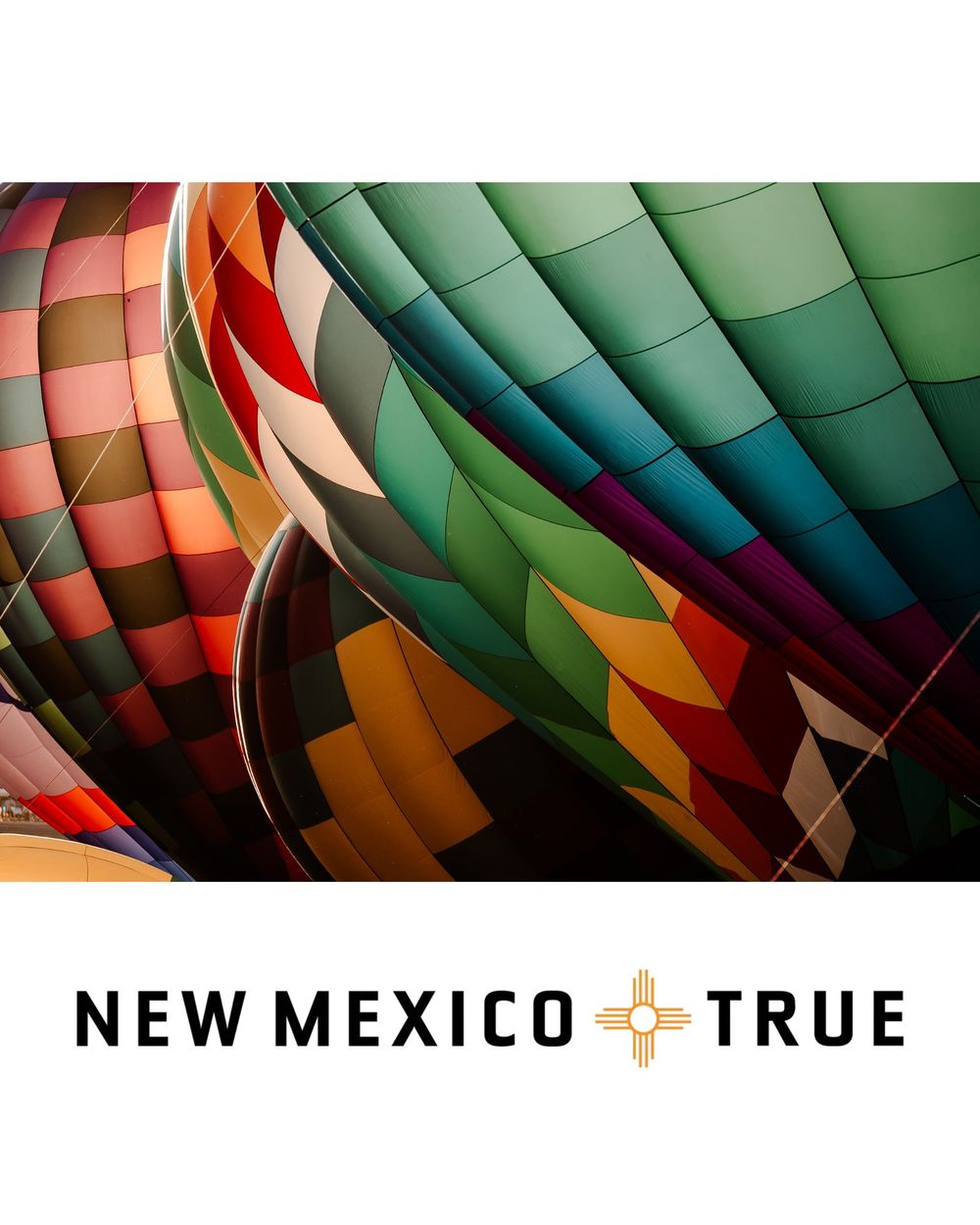 Colorful hot air balloons with vibrant patterns in teal, red, and gold, branded with New Mexico True logo.