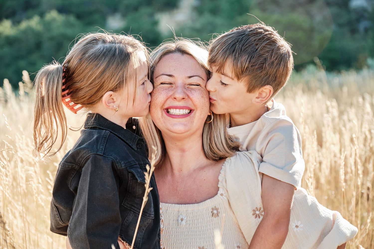 a mother being kissed by her two kids