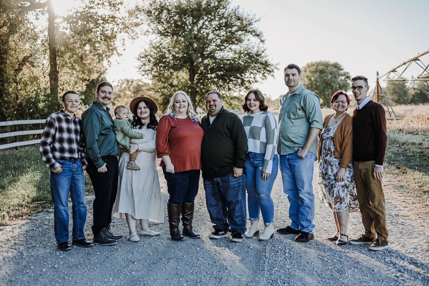 Extended family group photo session outdoors with multiple generations posed together. Extended family photography