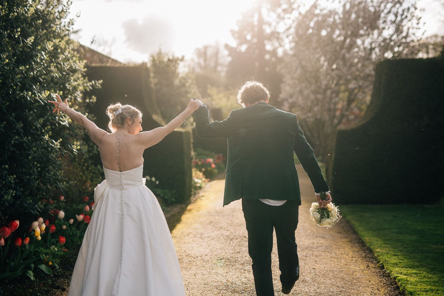 Intimate wedding couple portraits taken in warm sunlight with natural foliage backdrop.