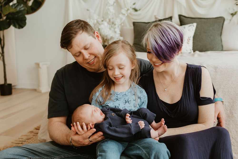 Four connected images showing intimate family moments with a newborn baby in a home setting.