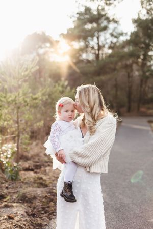 Intimate sunset portrait against a backdrop of pine trees on a winding path.