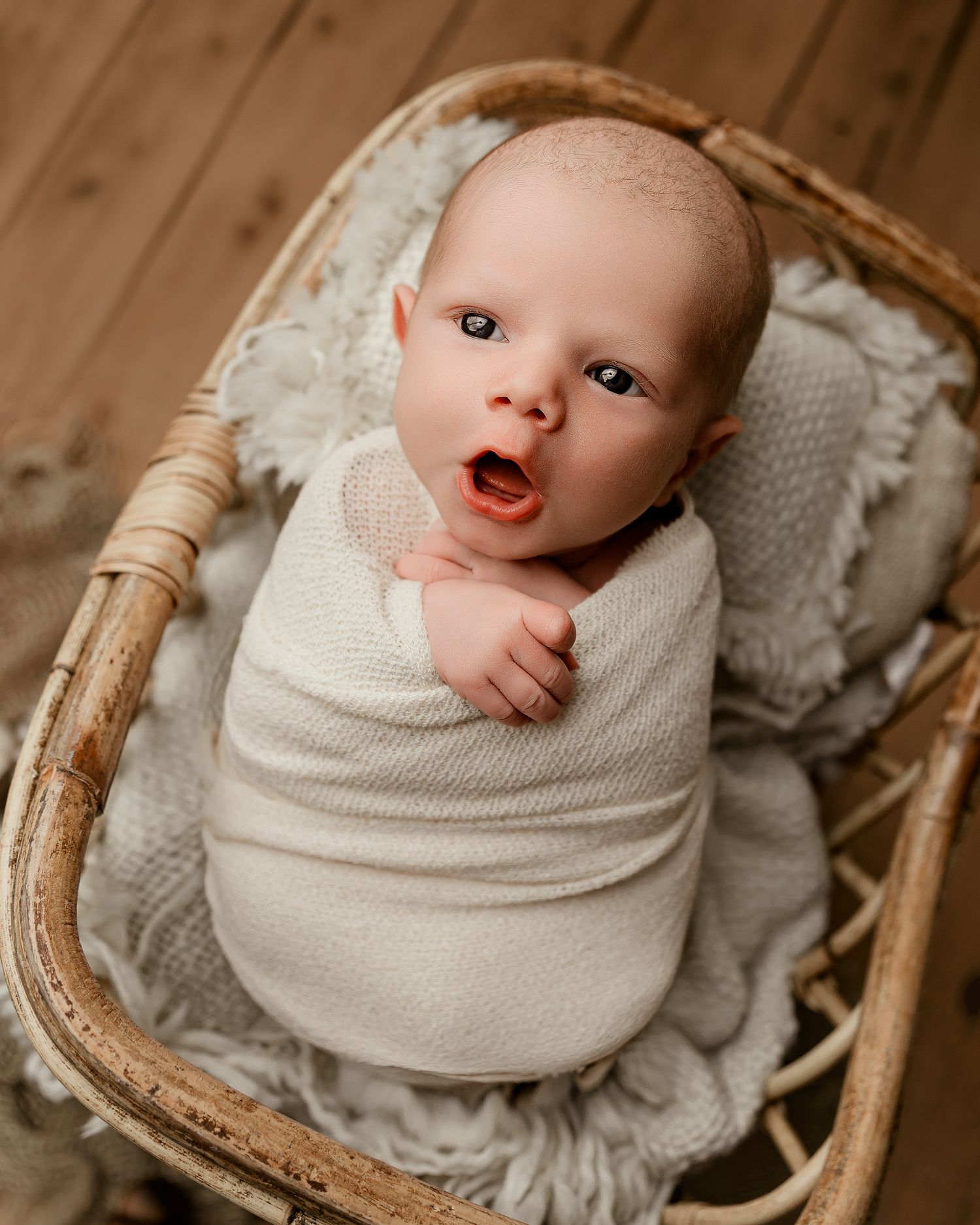Close-up of tiny newborn feet with delicate lace detail.
