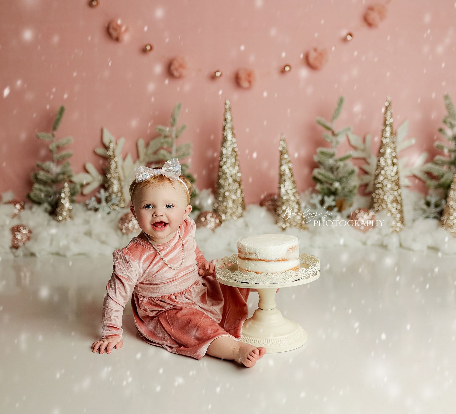First birthday cake smash photos by Bailey’s Photography in Southern Ohio featuring a smiling baby and custom designed backdrop