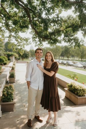 A couple poses together in a sunny outdoor setting with trees and stone architecture in a series of candid shots.