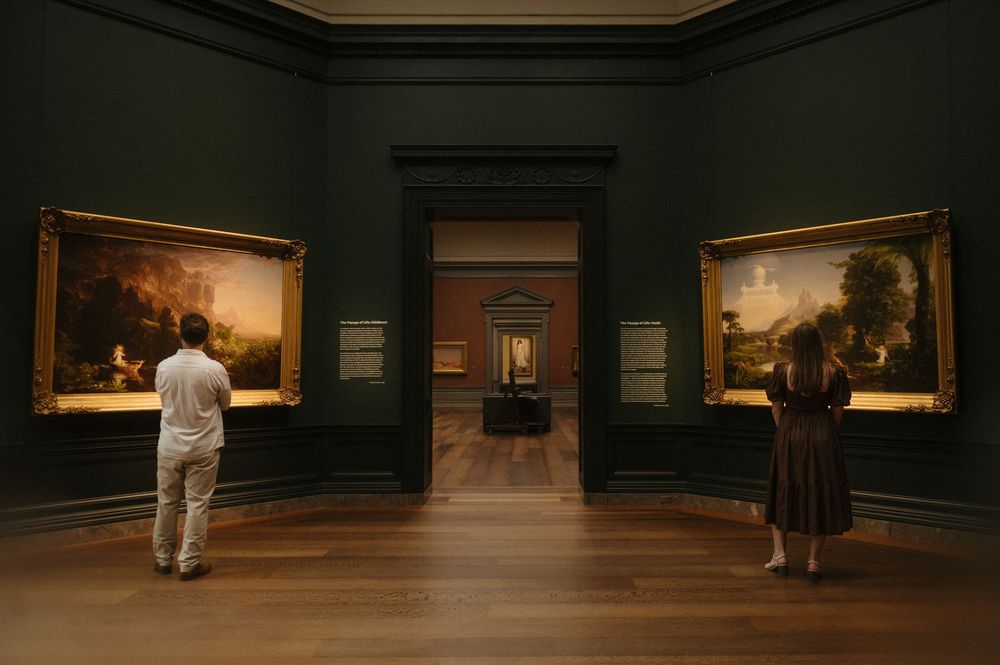 A series of art gallery scenes showing visitors viewing paintings on dark green walls in dim lighting.