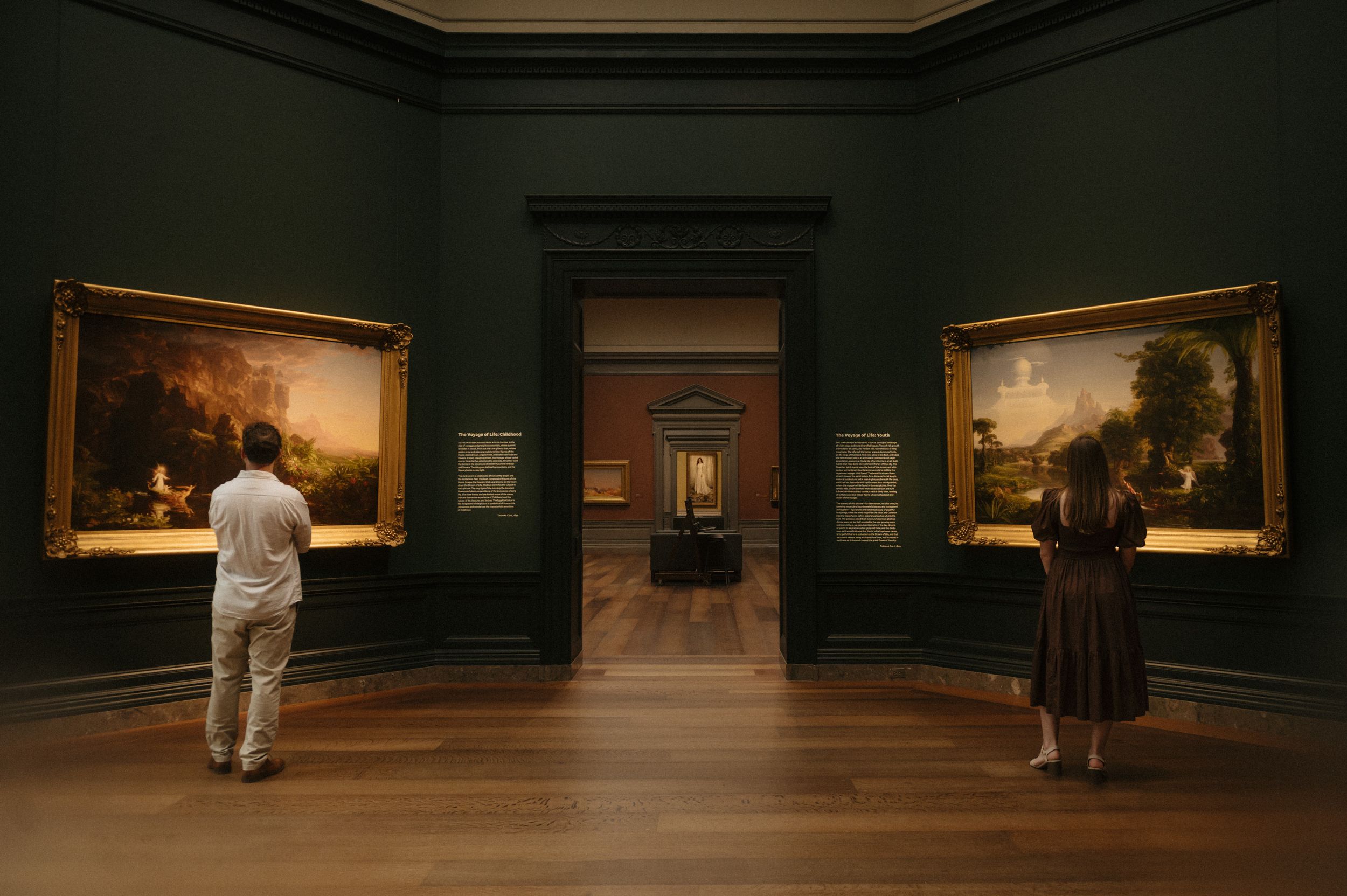 A series of art gallery scenes showing visitors viewing paintings on dark green walls in dim lighting.