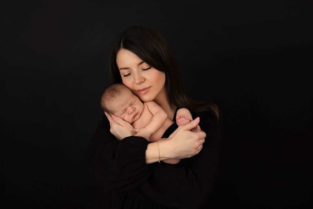A collection of intimate black and white portraits showing tender moments and expressions in low-key lighting.