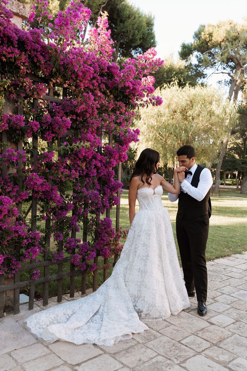 Romantic wedding photo sequence showing couple posing in front of vibrant pink bougainvillea flowers on stone patio.