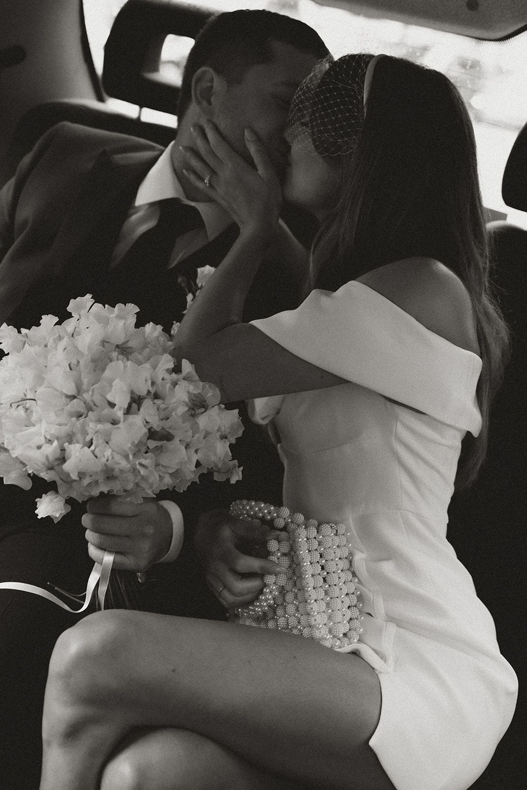 bride and groom sat on the stairs for relaxed wedding photographs at Kin house, wiltshire