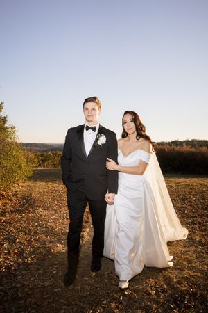 bride and groom walking towards camera during sunset at view at Morgan hill