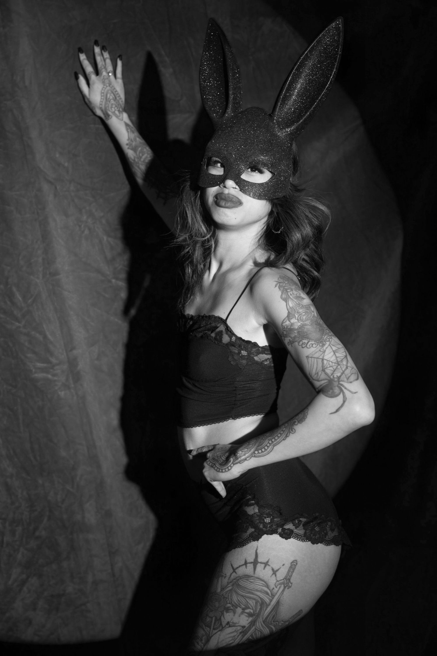 Artistic black and white boudoir photography series showcasing elegant poses and tattoo artwork.