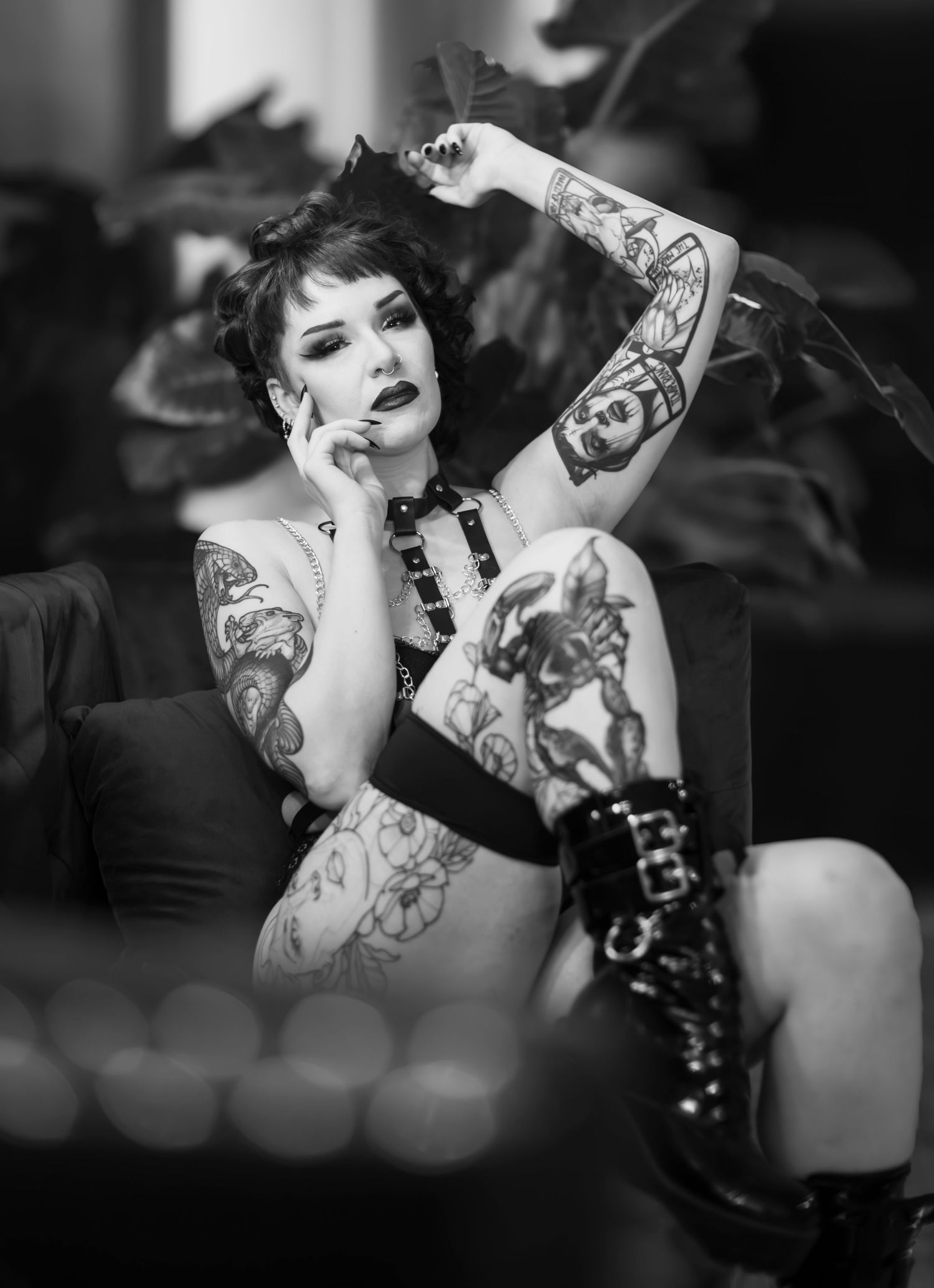Black and white portrait of tattooed woman in dark glamour style.