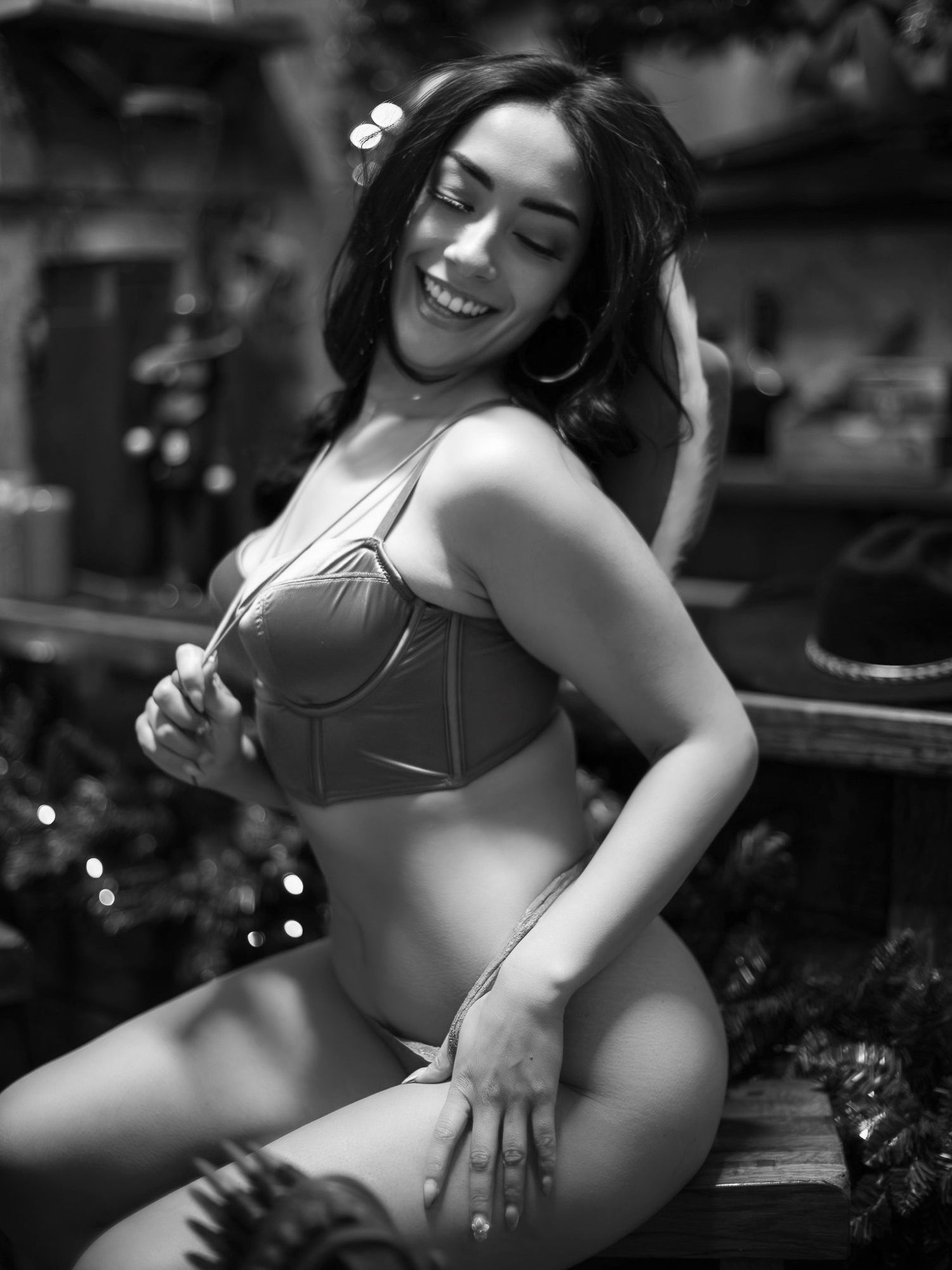Black and white boudoir photography session featuring artistic poses and natural lighting effects.