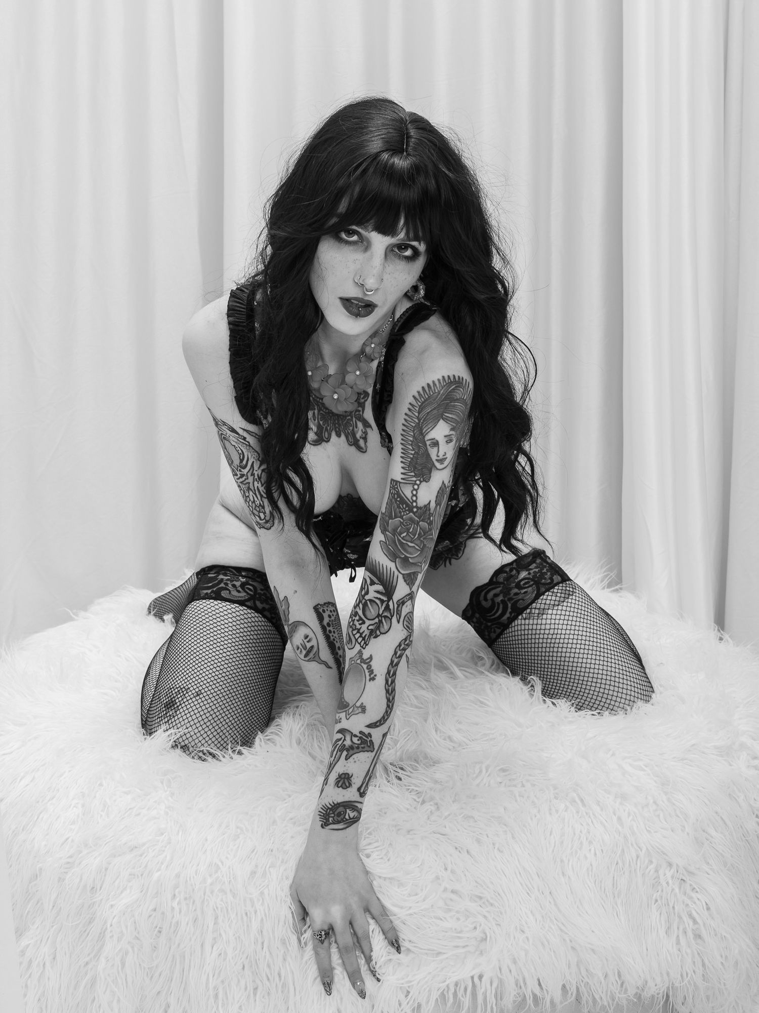 Monochromatic fashion portrait series showing model in lace against white background with dramatic poses.