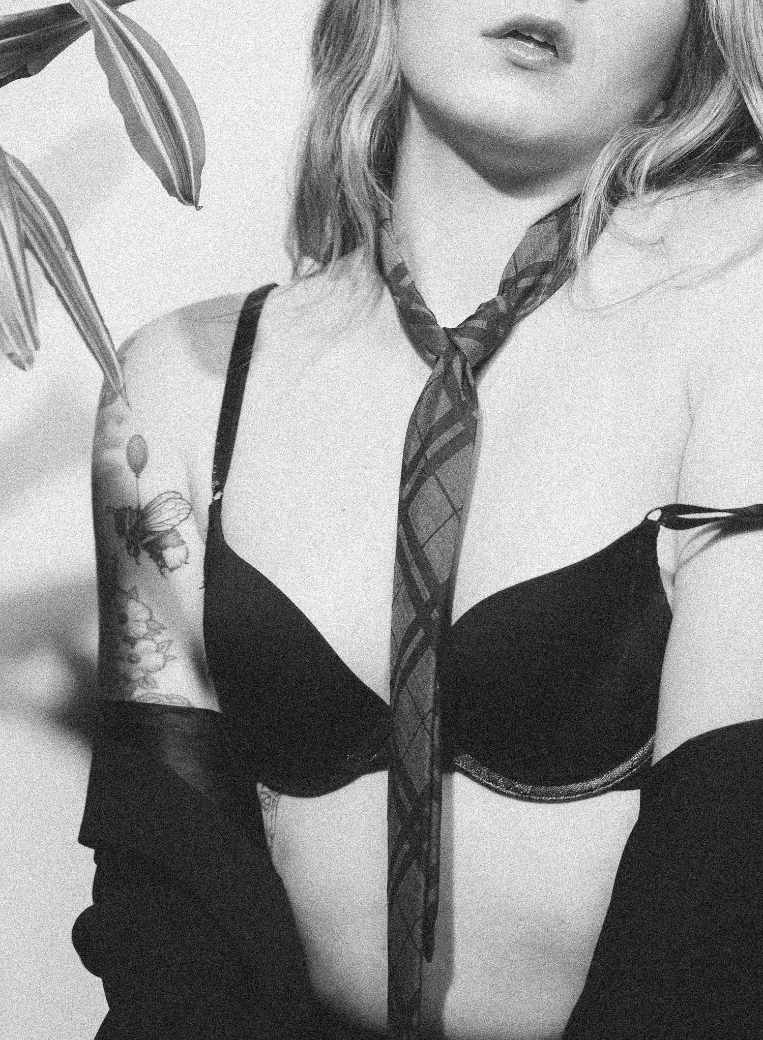Artistic black and white photo series showing close-up views of a person wearing black lingerie.