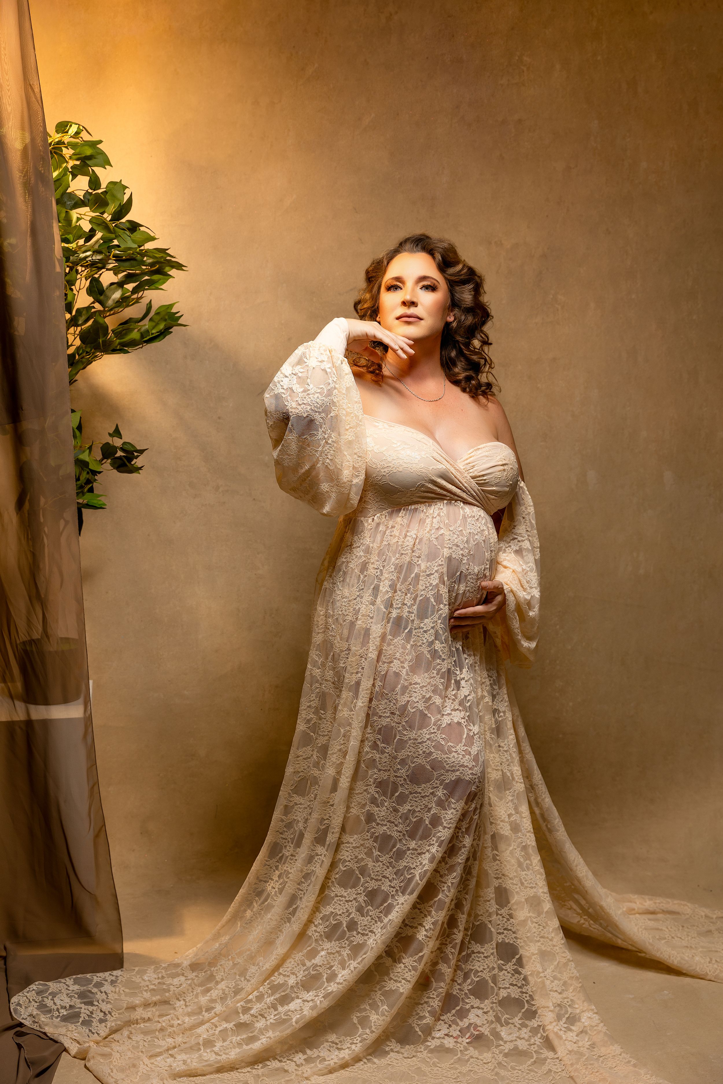 Silhouette of pregnant woman in black dress shown in four artistic profile poses against white background.