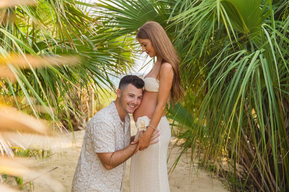 Romantic moment among tropical palm trees on beach path.
