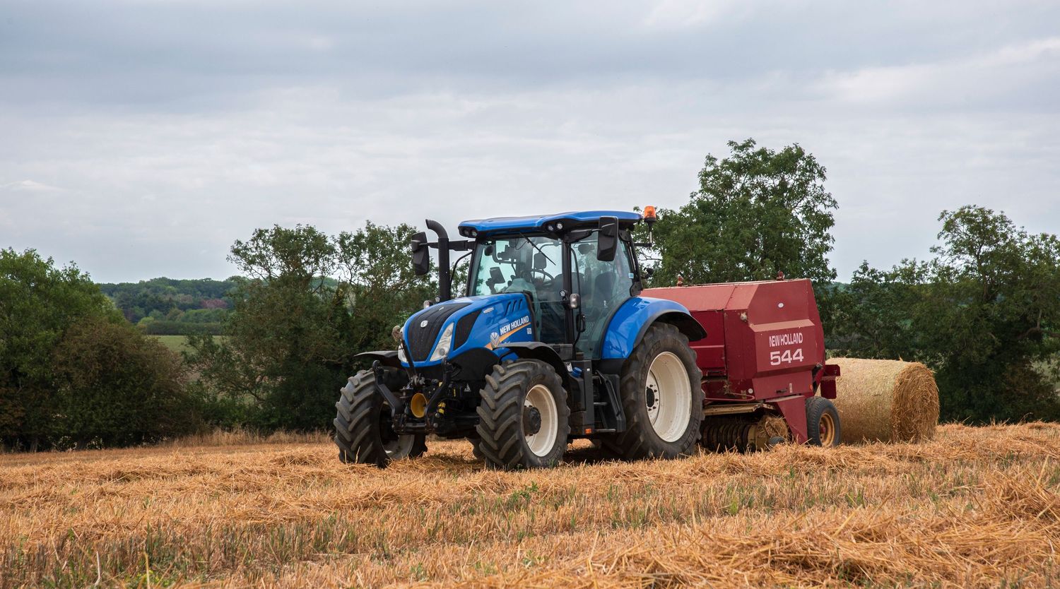 product photos of a tractor in the field harvesting