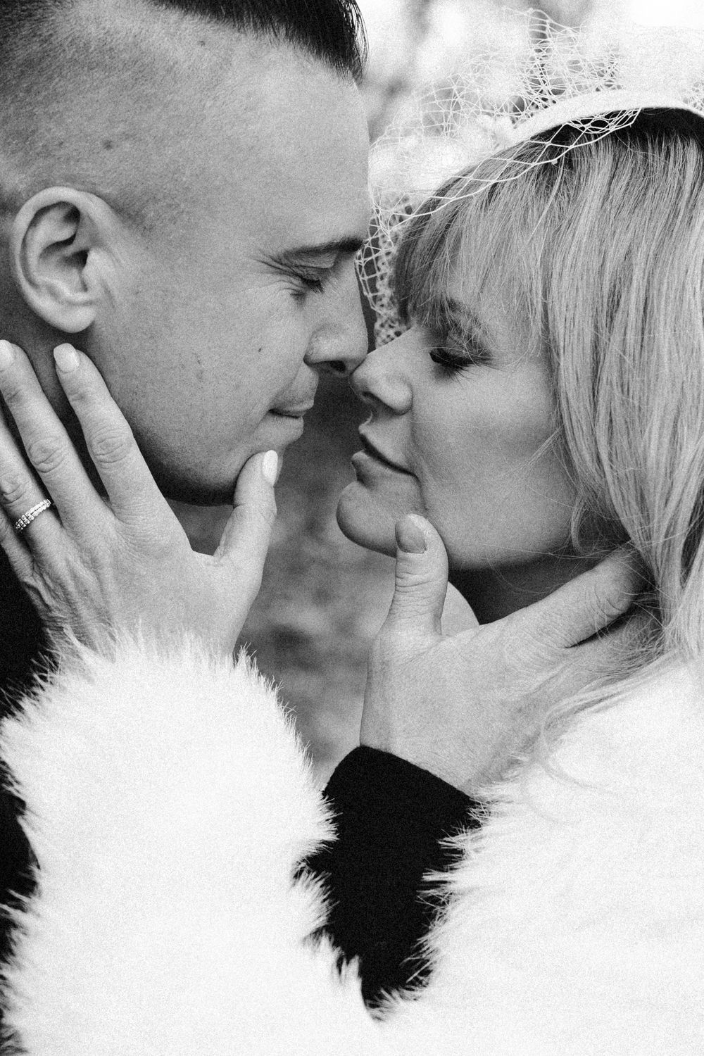 A romantic black and white photo series showing an intimate couple in close embrace sharing tender moments.