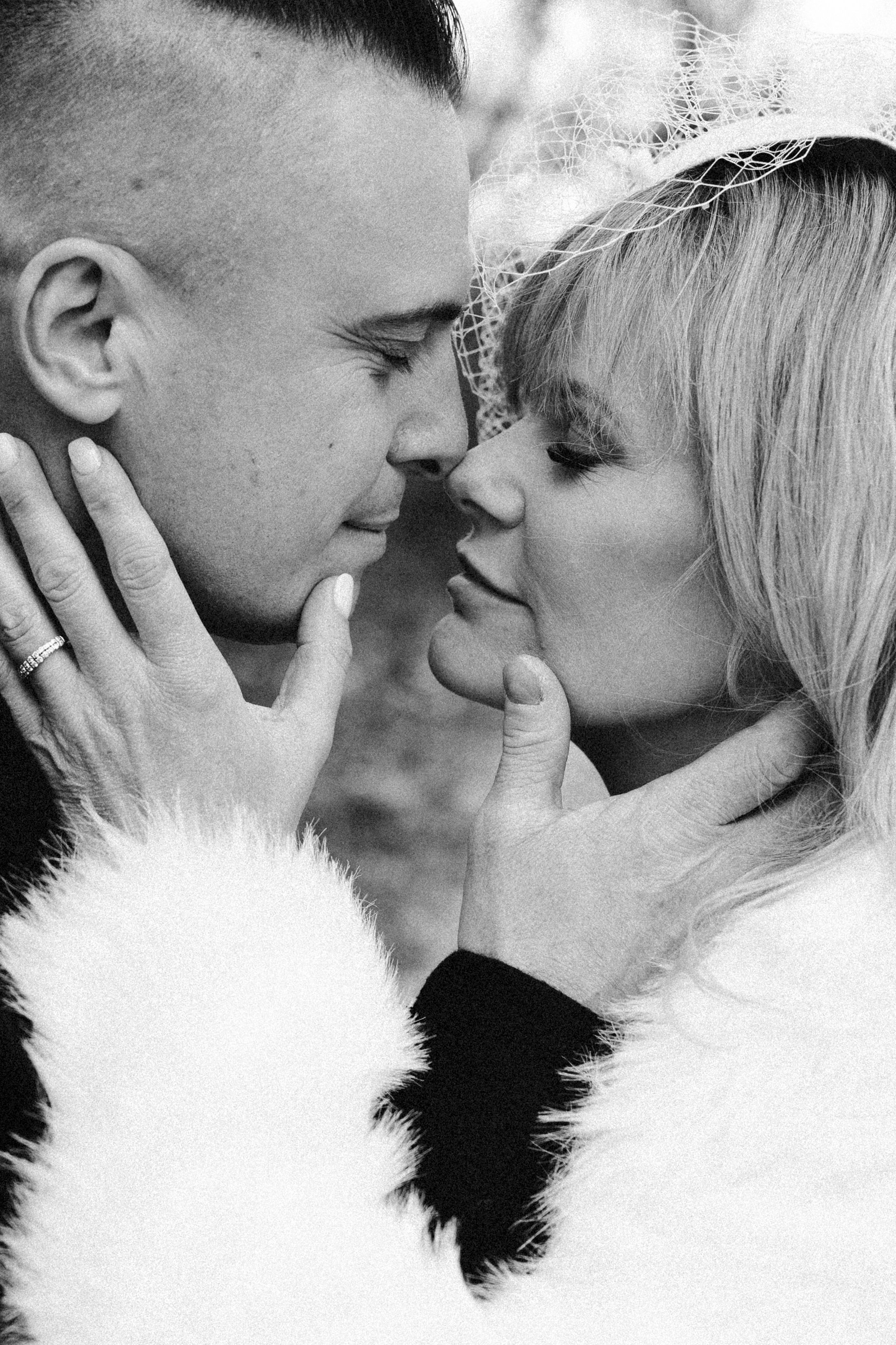 A romantic black and white photo series showing an intimate couple in close embrace sharing tender moments.