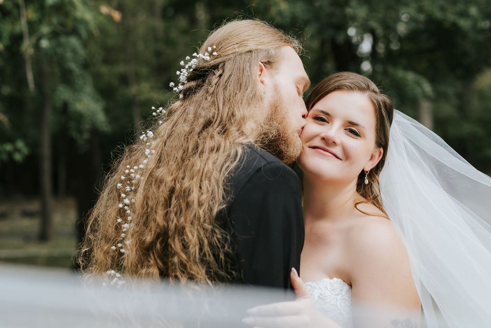 A joyful moment captured between two people embracing outdoors in a natural setting.