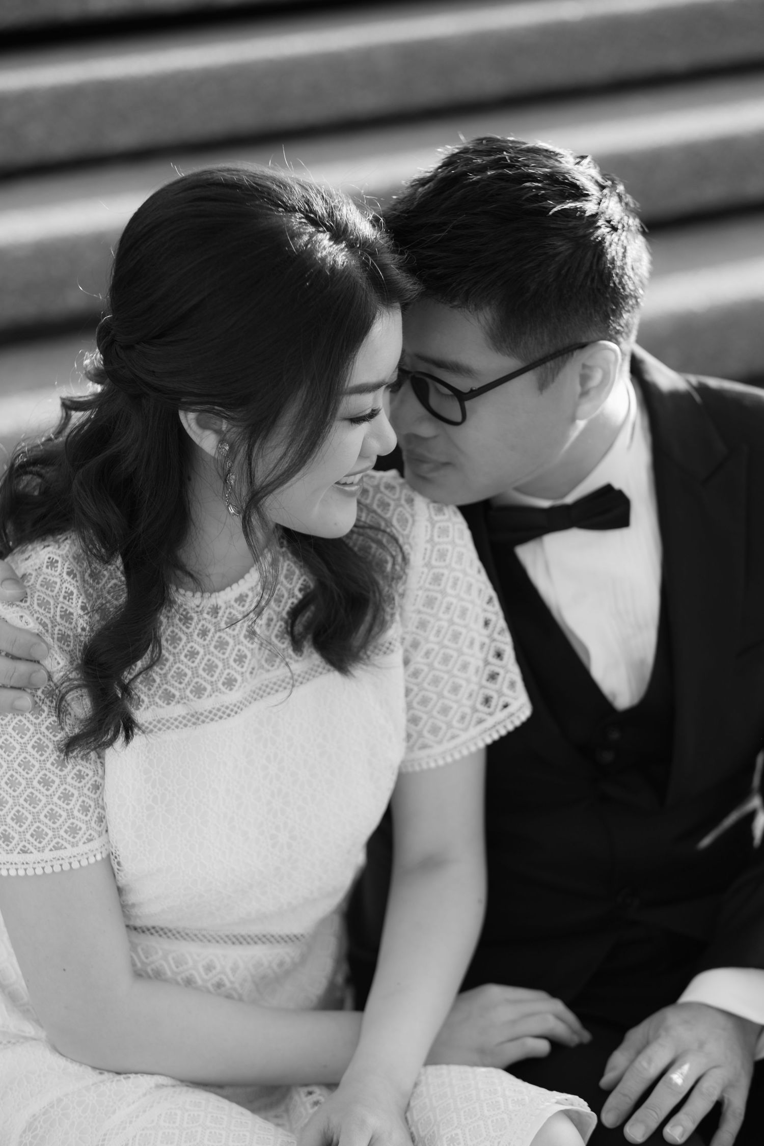 An intimate black and white portrait showing a tender romantic moment.