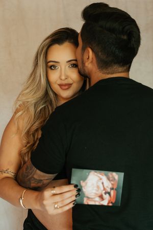Intimate maternity photo showing couple holding ultrasound photo.