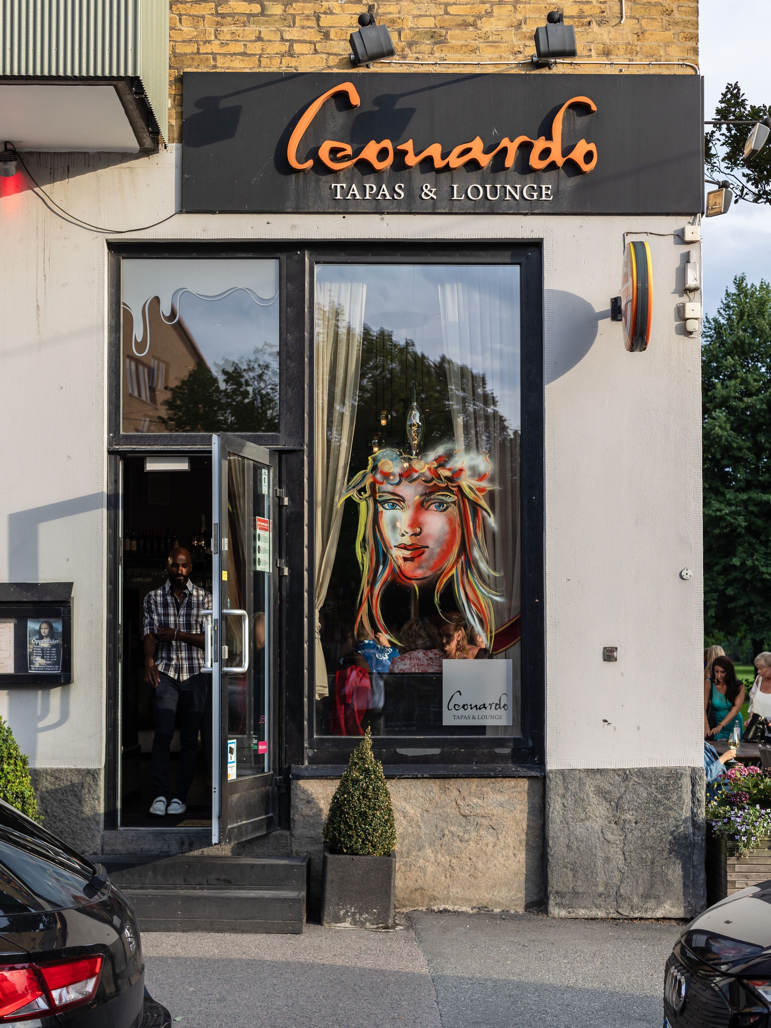 Leonardo Tapas & Lounge storefront exterior featuring artistic signage and decorative window display.